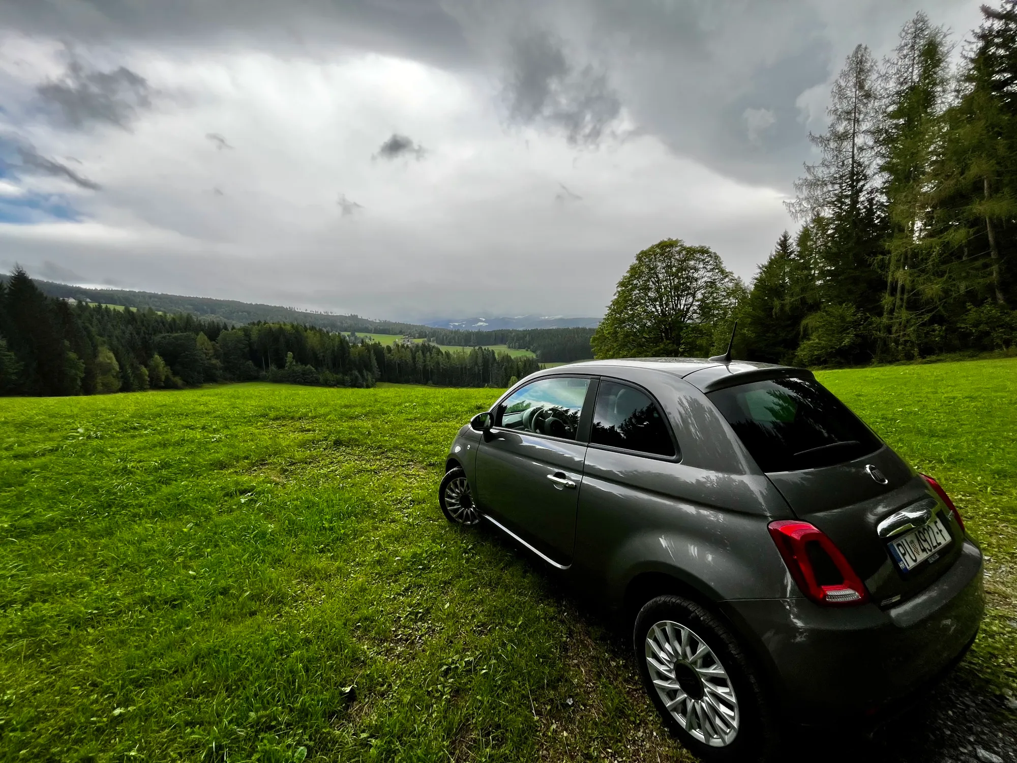 Car parked overlooking hill in rural Austria