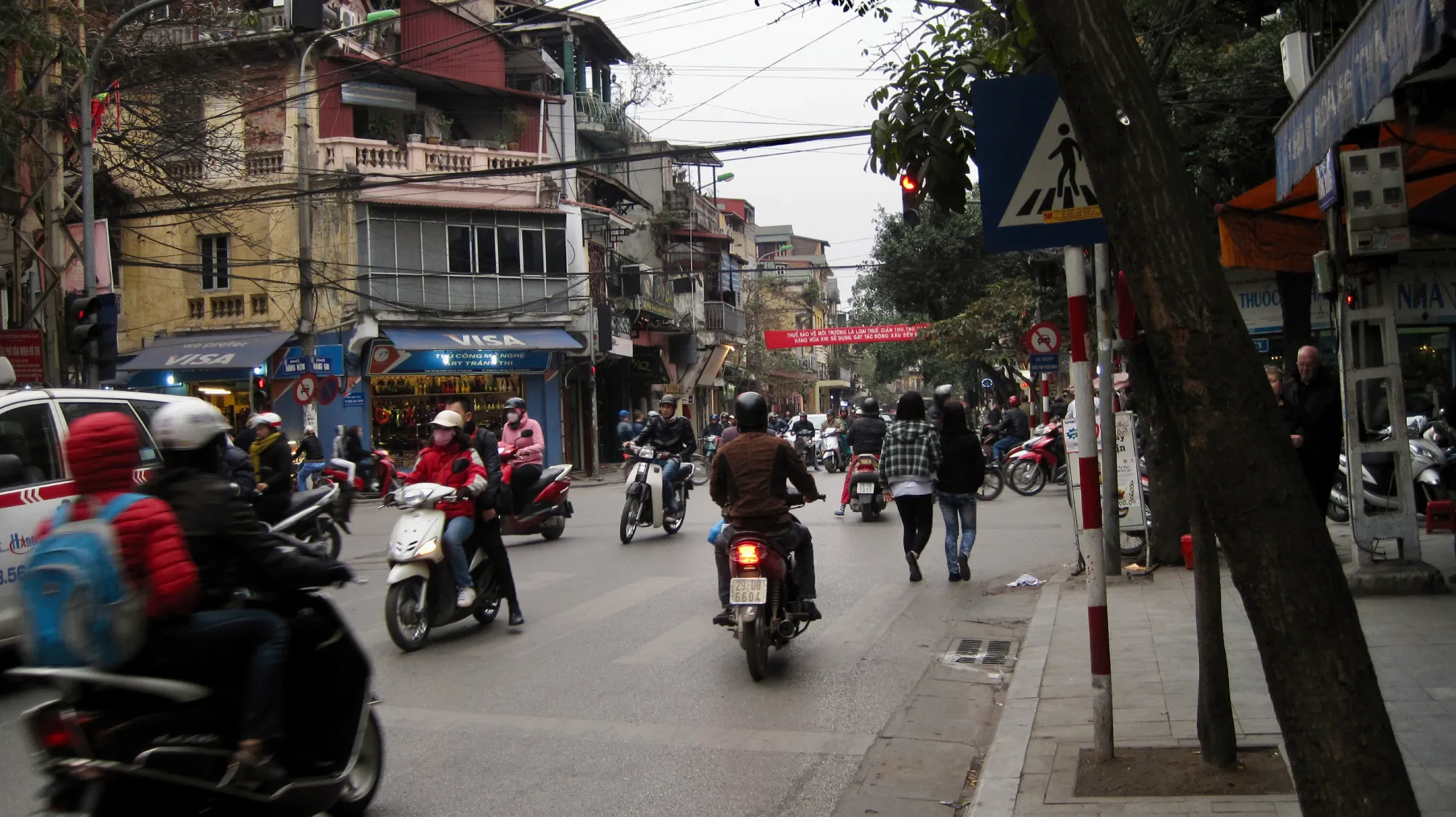 Scooters converge in an intersection in Hanoi, Vietnam